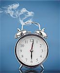 Smoking alarm clock on blue background