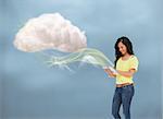 Casual girl using tablet to connect to cloud computing against blue background