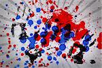 Blue and red paint splashes with black hand prints on grey linear pattern
