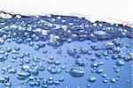 Close up on blue water with bubbles