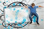 Skateboarder mid ollie in front of copy space screen with blue paint splashes and black decorative frame