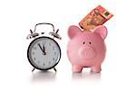 Alarm clock and piggy bank with fifty euro sticking out on white background