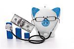 Blue and white piggy bank wearing glasses and stethoscope listening to graph model