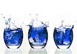 Serial arrangement of blue liquid splashing in tumbler on white background