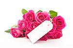 Close up of a bouquet of pink roses with an empty card on a white background