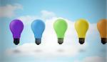 Five colored light bulbs against sky background
