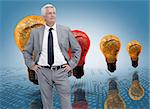 Businessman in front of colored light bulbs in row
