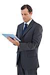 Charismatic businessman holding a tablet pc on white background