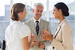 Smiling colleagues discussing together in their office