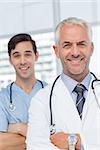 Smiling doctors with arms crossed looking at the camera