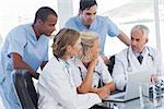 Smiling medical team using laptop to work