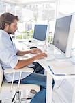 Designer working on the computer at desk in modern office