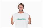 Happy man wearing volunteer tshirt giving thumbs up on white background