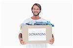 Happy man carrying donation box on white background