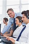 Call centre working with headset in a bright office