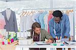 Two fashion designers working together on a desk