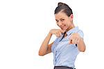 Smiling businesswoman pointing something with fingers on a white background