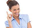 Smiling businesswoman pointing upwards with finger