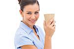 Businesswoman carrying coffee cup looking at the camera