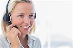 Businesswoman talking on headset and smiling