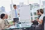 Manager standing in front of colleagues during a meeting