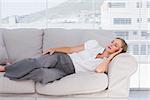 Businesswoman lying on couch in the office