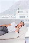 Relaxed businesswoman lying on couch in the office