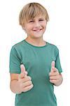 Smiling young boy with a green shirt on white background