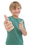 Blonde boy giving thumbs up and pointing on white background