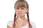 Young girl with her finger on her mouth on white background