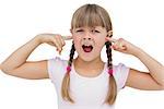 Little girl clogging her ears with her fingers on white background