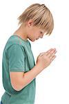 Little boy praying with bowed head on white background