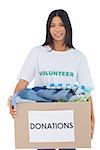 Happy woman carrying donation box on white background