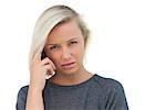 Blonde woman suffering with headache on white background