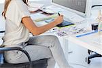 Photo editor pointing using graphics tablet in her office