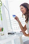 Attractive designer purchasing online with her credit card