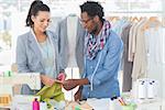 Creative designers talking about one green textile in a studio