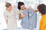 Attractive women looking at blazer in a studio