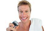 Handsome man holding an electric razor on white background