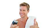 Cheerful man giving thumbs up while holding an electric razor on white background