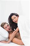 Embarrassed couple caught in the act in bed