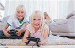 Siblings playing video games in the living room