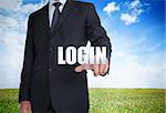 Businessman selecting login word with landscape on the background