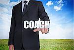 Businessman selecting coach word with landscape on the background