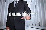 Businessman selecting the term online support in a data center