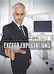 Businessman touching the term exceed expectations in his office