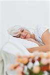 Peaceful mature woman sleeping in bed