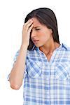 Sick woman with a headache and hand on forehead against white background