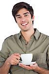 Smiling man holding cup of coffee and looking at the camera