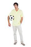 Serious man holding soccer ball on a white background